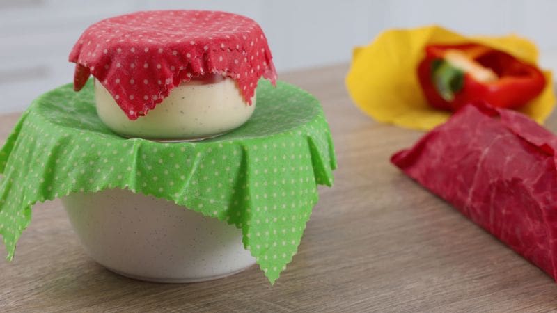 Food containers covered with beeswax wraps instead of plastic wrap or aluminum foil.