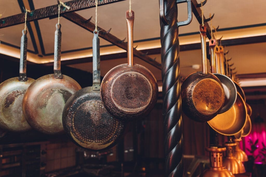 Cleaning a cast iron skillet properly before hanging it up on a pan rack above your stove. 